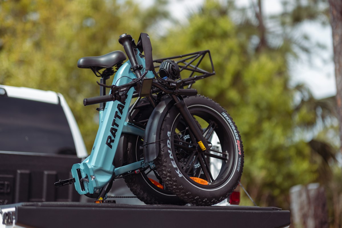 a blue bike is on the back of a truck