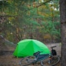 a tent and bicycles in a forest